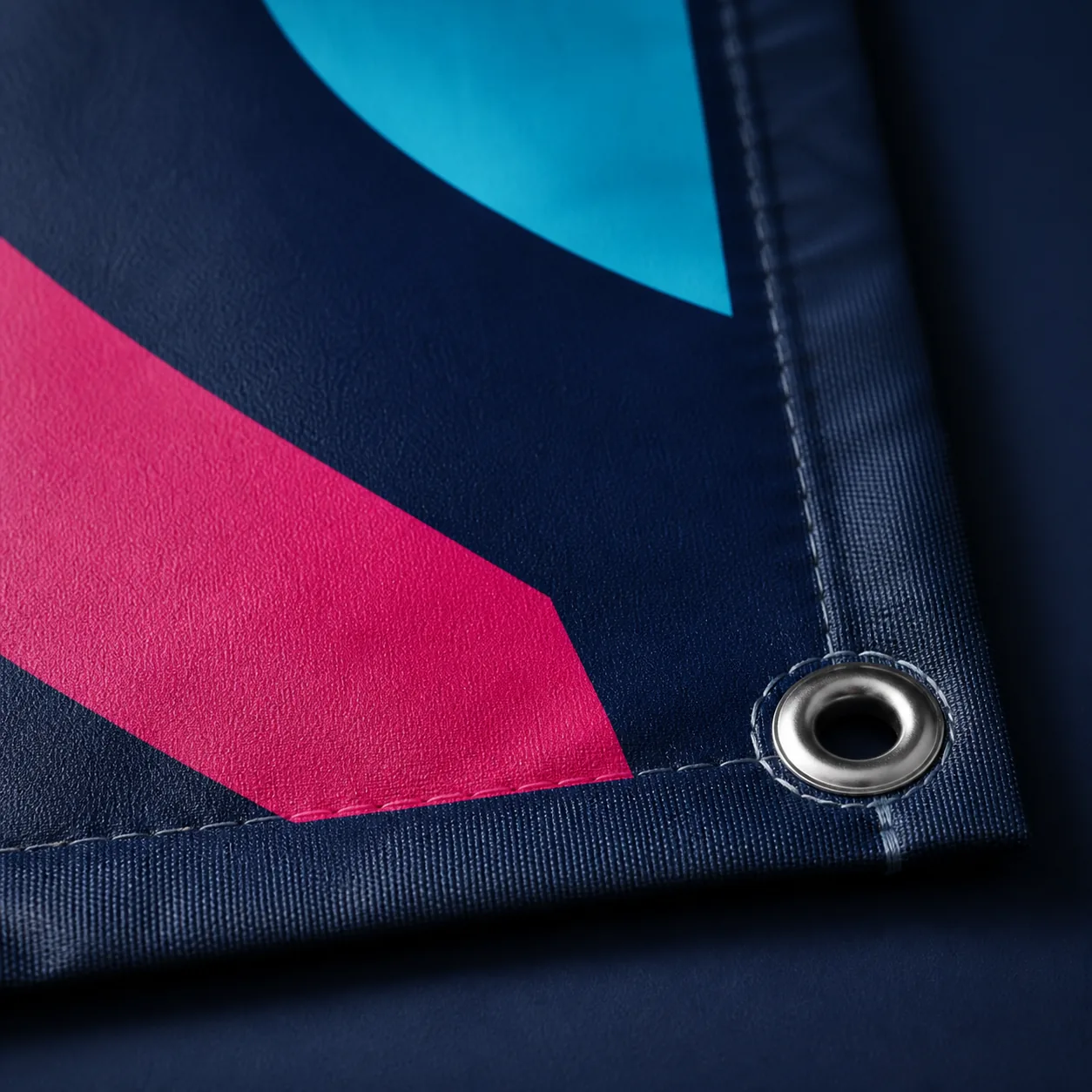 Close-up of a sharply printed matte banner with reinforced edging and a metal eyelet.